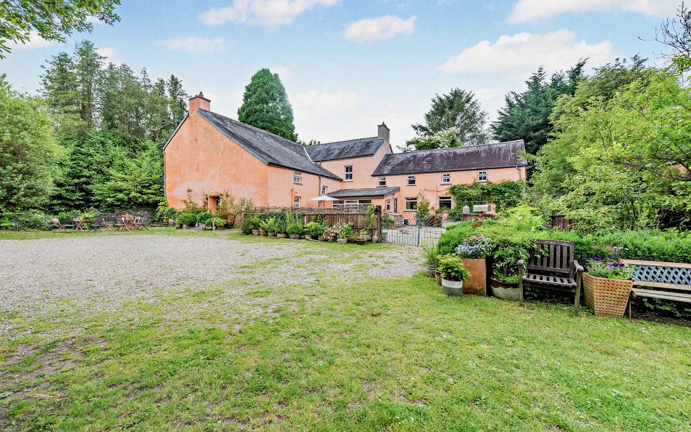 Velindre House courtyard and peach-coloured exterior surrounded by greenery