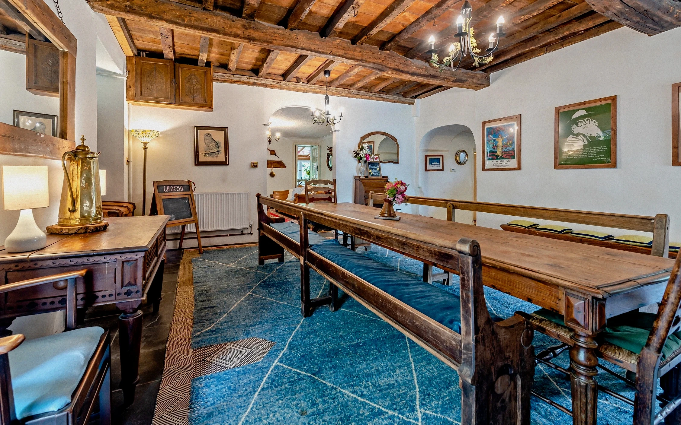 Large cream canvas tent prepared for yoga in the garden, with mats and flowers among lush greenery.