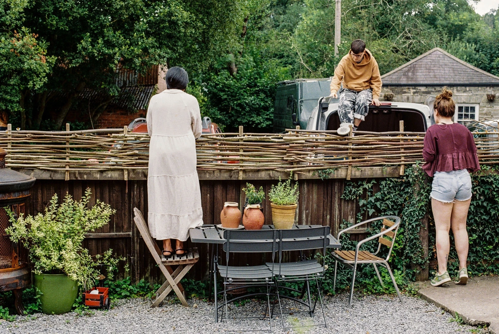 Stone outbuilding with flower pots and ivy